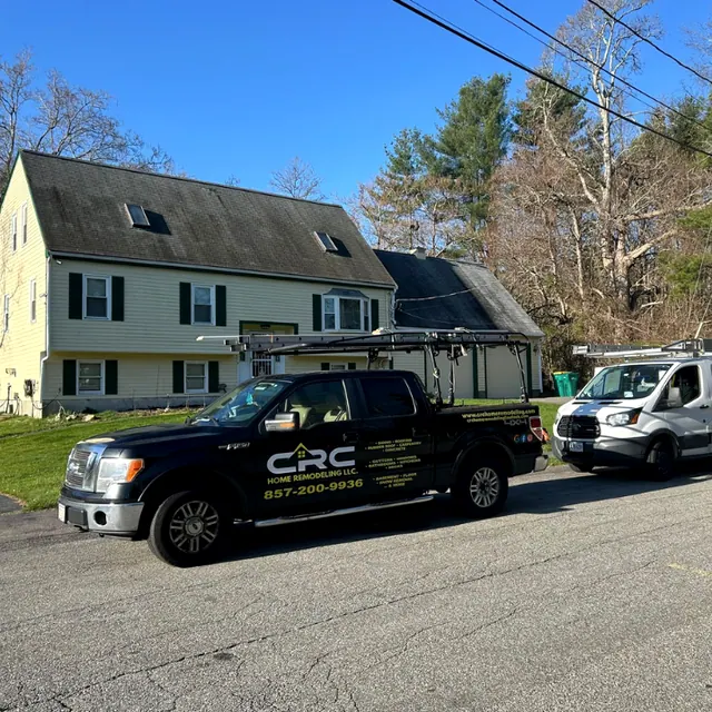 Black CRC company pickup truck parked at a job site in front of a gray cape