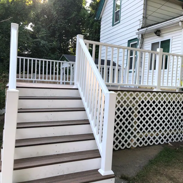 New deck stairs with two-tone composite treads, white vinyl railings and lattice skirting